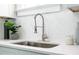 Modern kitchen features a farmhouse sink with a sleek gooseneck faucet at 943 Rose Sw Cir, Atlanta, GA 30310