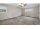 Spacious bedroom with carpet flooring, ceiling fan, and multiple windows at 1800 Trophy Dr, Marietta, GA 30062