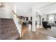 View of a carpeted staircase, hardwood floors, and open kitchen at 2134 Woodmarsh Cir, Auburn, GA 30011