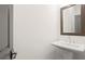 Simple bathroom with pedestal sink and framed mirror at 201 Devore Rd, Alpharetta, GA 30009