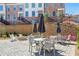 Community courtyard with tables, chairs, fire pit, and umbrellas at 201 Devore Rd, Alpharetta, GA 30009