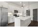 Modern kitchen with white cabinets, stainless steel appliances and island at 201 Devore Rd, Alpharetta, GA 30009