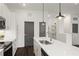 Modern kitchen with white cabinets, island, and dark gray doors at 201 Devore Rd, Alpharetta, GA 30009