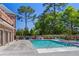 Community pool with lounge chairs and landscaping at 201 Devore Rd, Alpharetta, GA 30009