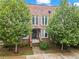 Brick townhouse with a welcoming front entrance and landscaping at 201 Devore Rd, Alpharetta, GA 30009