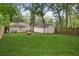 Large backyard with lush green grass, fire pit, and shed at 1273 Boulevard Lorraine Sw, Atlanta, GA 30311