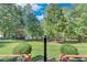 Private backyard with lush landscaping and lake views at 7280 Timber Trl, Cumming, GA 30041