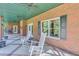 Brick covered porch with rocking chairs and lake view at 7280 Timber Trl, Cumming, GA 30041