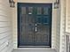 Black double front doors with sidelights and exterior lanterns at 226 Oak Hill Ct, Lithia Springs, GA 30122