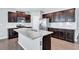 Modern kitchen island with granite countertops and dark cabinets at 116 Paulownia Cir, Mcdonough, GA 30253