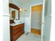 Elegant bathroom with antique vanity, vessel sink and marble flooring at 1512 Silver Maple Sw Ct, Lilburn, GA 30047