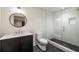 Modern bathroom with marble vanity, walk-in shower, and dark-grey floor tiles at 95 Montgomery Ferry Ne Dr, Atlanta, GA 30309