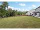 Expansive backyard with grassy lawn and wooden fence at 6172 Collins Nw Rd, Acworth, GA 30101