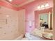 Pink bathroom with granite countertop, shower, and updated fixtures at 5004 Gunnison Trce, Suwanee, GA 30024