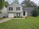 Two-story house with gray siding, a double-car garage, and a well-maintained lawn at 1378 Mill Lake Cir, Stone Mountain, GA 30088