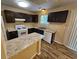 Eat-in kitchen with an island, dark cabinets, and vinyl flooring at 1378 Mill Lake Cir, Stone Mountain, GA 30088