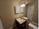 Bathroom with a vanity, mirror, and wood-look flooring at 1378 Mill Lake Cir, Stone Mountain, GA 30088