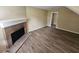 Spacious living room featuring a brick fireplace and wood-look vinyl flooring at 1378 Mill Lake Cir, Stone Mountain, GA 30088