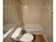 Clean bathroom with a tub, toilet, and updated flooring at 1378 Mill Lake Cir, Stone Mountain, GA 30088