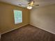 Bright bedroom with a window, ceiling fan, and brown carpet at 1378 Mill Lake Cir, Stone Mountain, GA 30088