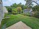 Large backyard with grassy area and a small patio at 1378 Mill Lake Cir, Stone Mountain, GA 30088