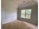 Bright bedroom featuring a large window and carpet at 2080 Winding Crossing Trl, Fairburn, GA 30213