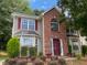 Two-story house with brick and siding, red shutters, and landscaping at 2080 Winding Crossing Trl, Fairburn, GA 30213