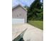 Attached garage with white door and concrete driveway at 2080 Winding Crossing Trl, Fairburn, GA 30213