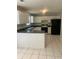 Kitchen with white cabinets and breakfast bar at 2080 Winding Crossing Trl, Fairburn, GA 30213