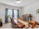 Well-lit dining room with wood table and gray curtains at 719 Sara Meadow Rd, Loganville, GA 30052