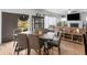 Bright dining area with a rustic wooden table and gray chairs, adjacent to the living room and kitchen at 719 Sara Meadow Rd, Loganville, GA 30052