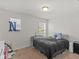 Well-lit bedroom featuring a bed, crib, and window at 719 Sara Meadow Rd, Loganville, GA 30052