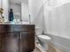 Clean bathroom with tub, shower, and dark brown vanity at 719 Sara Meadow Rd, Loganville, GA 30052