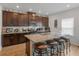 Modern kitchen with dark wood cabinets, granite countertops, and stainless steel appliances at 719 Sara Meadow Rd, Loganville, GA 30052