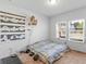 Comfortable bedroom with a double bed, neutral decor, and plenty of natural light at 719 Sara Meadow Rd, Loganville, GA 30052