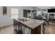 Kitchen island with granite countertops and a double sink, offering extra prep space at 719 Sara Meadow Rd, Loganville, GA 30052
