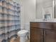 Clean bathroom with shower/tub combo and dark brown vanity at 719 Sara Meadow Rd, Loganville, GA 30052