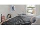 Cozy bedroom with a bed, crib, and window with blinds at 719 Sara Meadow Rd, Loganville, GA 30052
