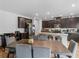Modern kitchen featuring dark brown cabinets, granite countertops, and a large island with seating at 719 Sara Meadow Rd, Loganville, GA 30052