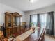 Bright dining room featuring a wood table and large windows at 719 Sara Meadow Rd, Loganville, GA 30052