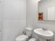 Small bathroom featuring a white pedestal sink and toilet at 719 Sara Meadow Rd, Loganville, GA 30052