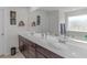 Double vanity bathroom with a large mirror at 719 Sara Meadow Rd, Loganville, GA 30052