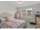 Bedroom with two windows, a pink dresser, and Eiffel Tower bedding at 719 Sara Meadow Rd, Loganville, GA 30052