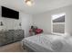 Bright bedroom with a large bed, dresser, and window at 719 Sara Meadow Rd, Loganville, GA 30052