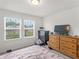 Bedroom with wood dresser, TV, and Eiffel Tower bedding at 719 Sara Meadow Rd, Loganville, GA 30052