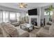 Open living room featuring a fireplace and a ceiling fan at 719 Sara Meadow Rd, Loganville, GA 30052