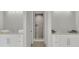Double vanity bathroom with a walk-in shower, modern fixtures and light flooring at 2000 Enon Sw Rd, Atlanta, GA 30331