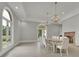 Formal dining room with a large table, chandeliers, and hardwood floors at 2000 Enon Sw Rd, Atlanta, GA 30331