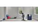 Bright home gym with stationary bike, weights, and exercise ball at 2000 Enon Sw Rd, Atlanta, GA 30331