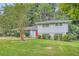 Gray house with red door, landscaping, and driveway at 3189 Dogwood Dr, Atlanta, GA 30344